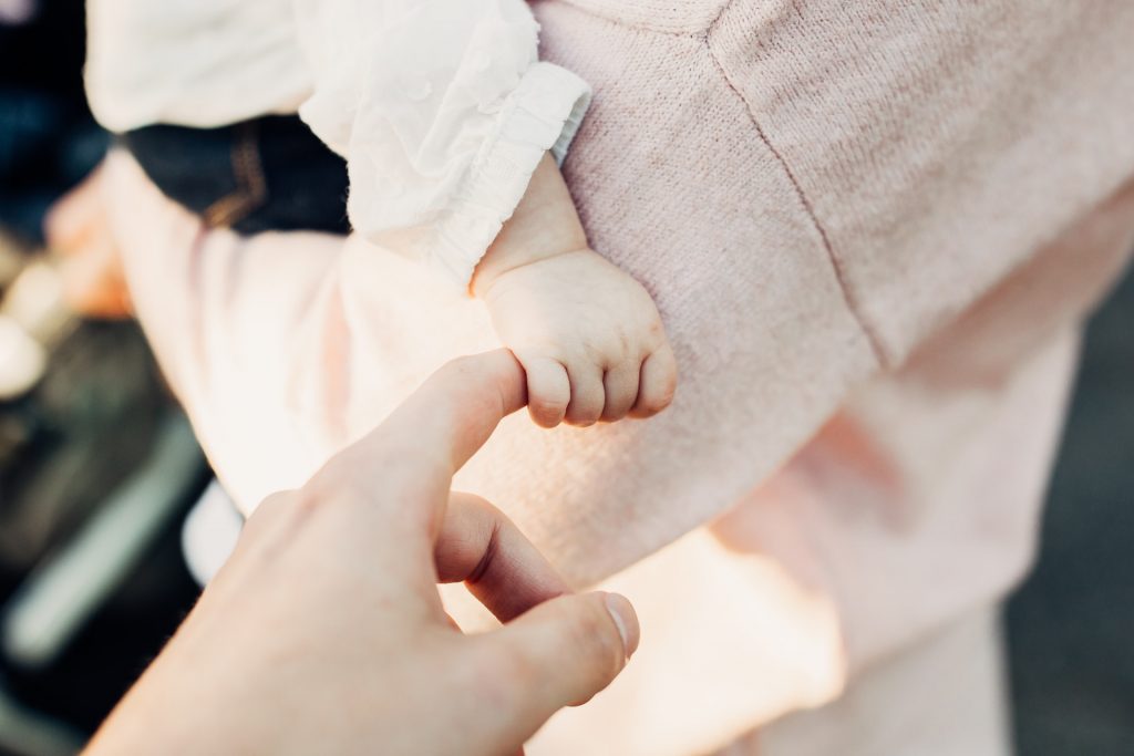 close-up of a person holding a baby