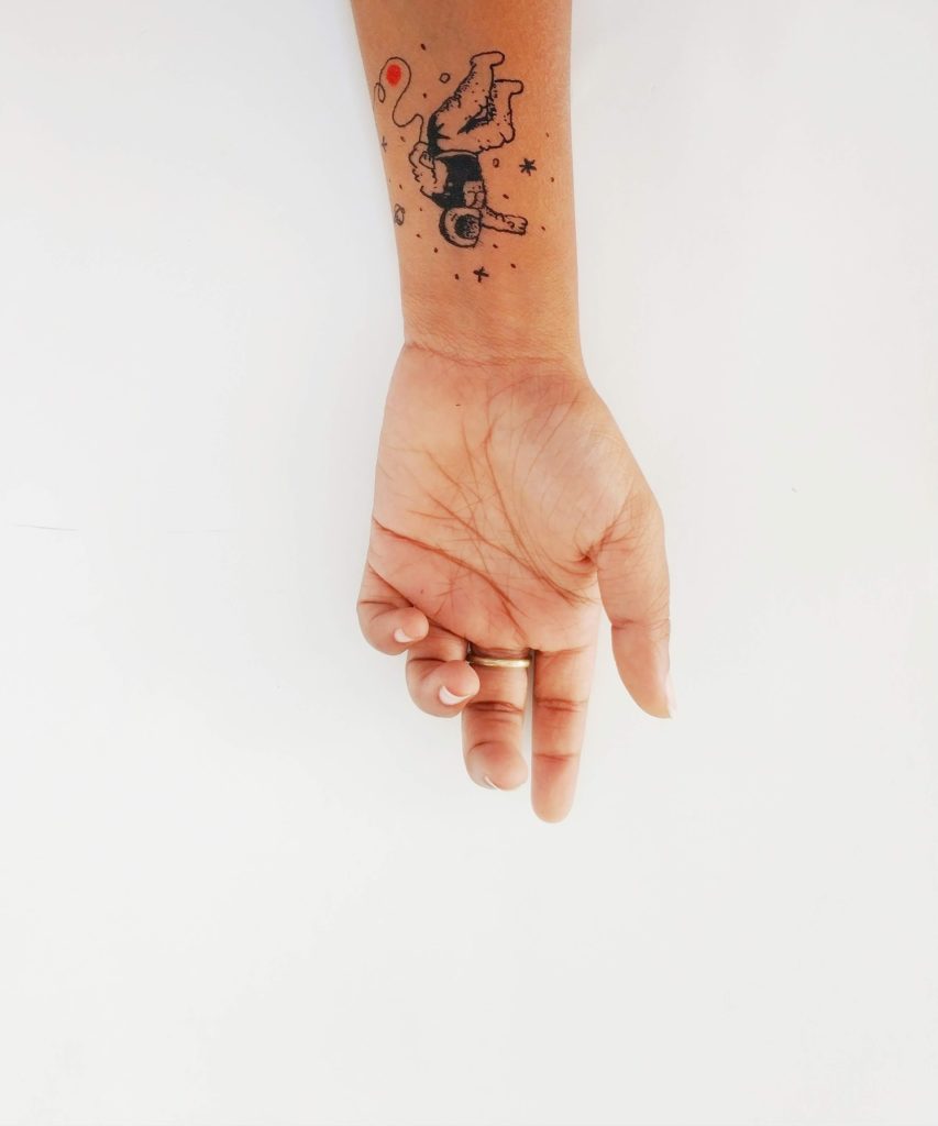 a hand with a tattoo on it
