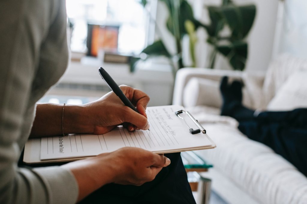 a person writing on a piece of paper