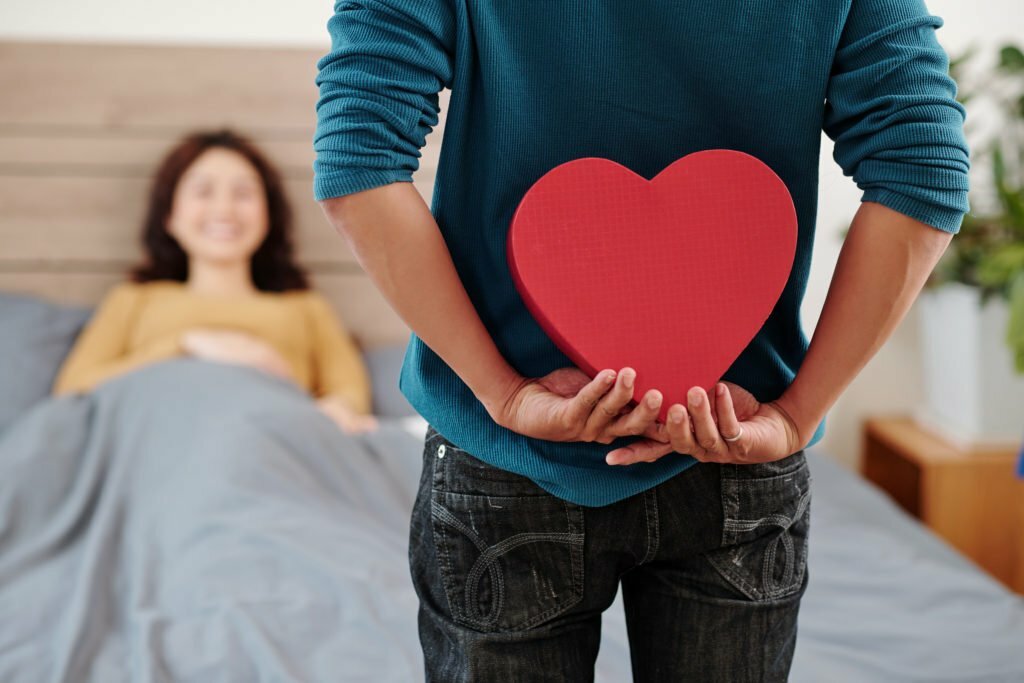 a person holding a red heart