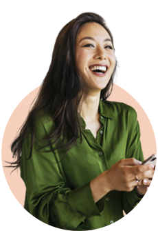a person smiling and holding a cell phone