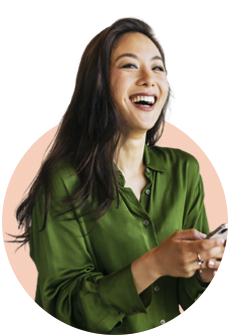 a person smiling and holding a cell phone