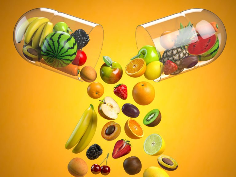 Different fruits in medical capsule, Vitamin dietary supplement and health nutrition concept.